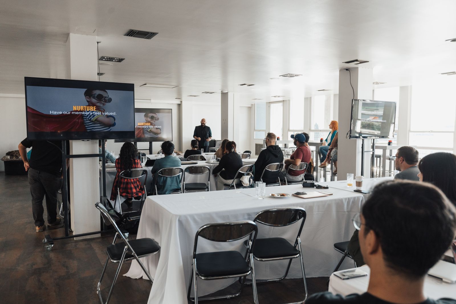 An audience listening to a presentation