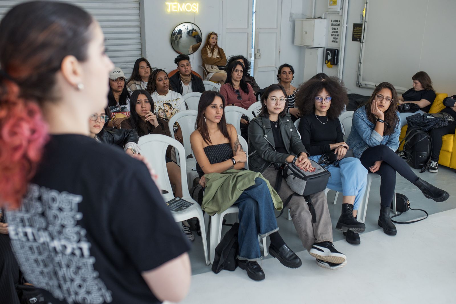 Adults listening attentively at an indoor workshop